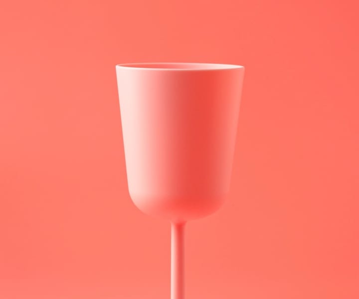 a pink cup with a pink background